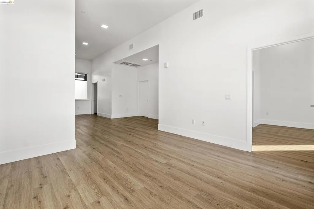 Spare room with light wood-style floors and recessed lighting