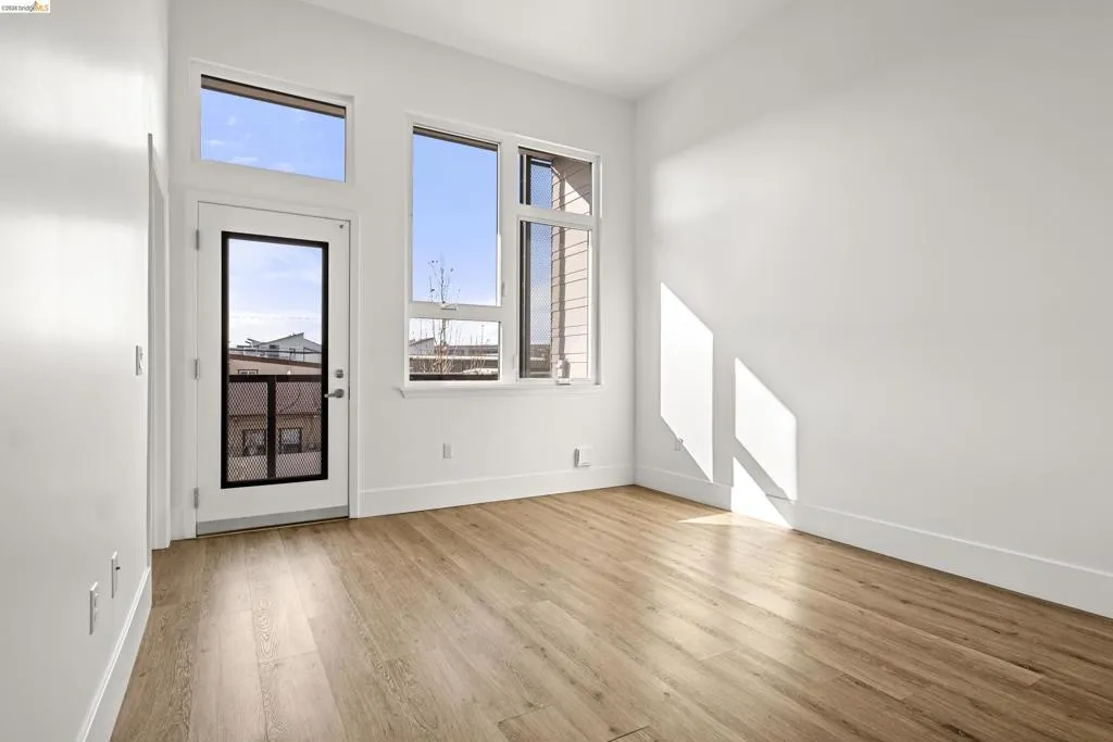 Unfurnished room with light wood-style flooring and baseboards