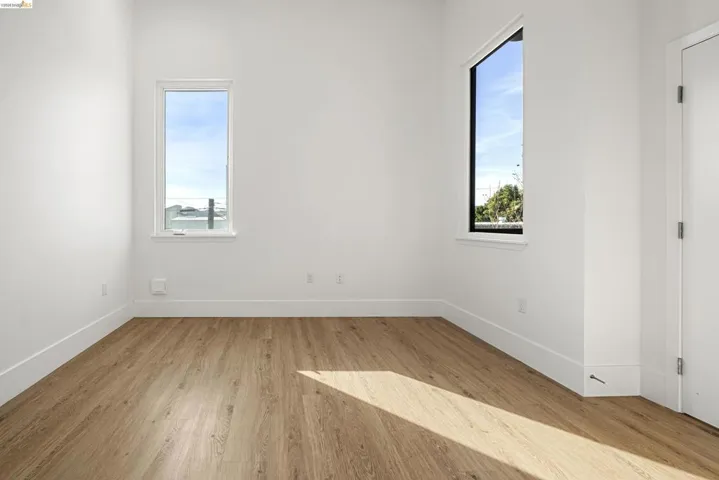 Unfurnished room featuring light wood-style flooring and plenty of natural light