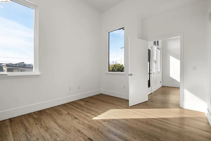 Empty room with light wood finished floors and baseboards