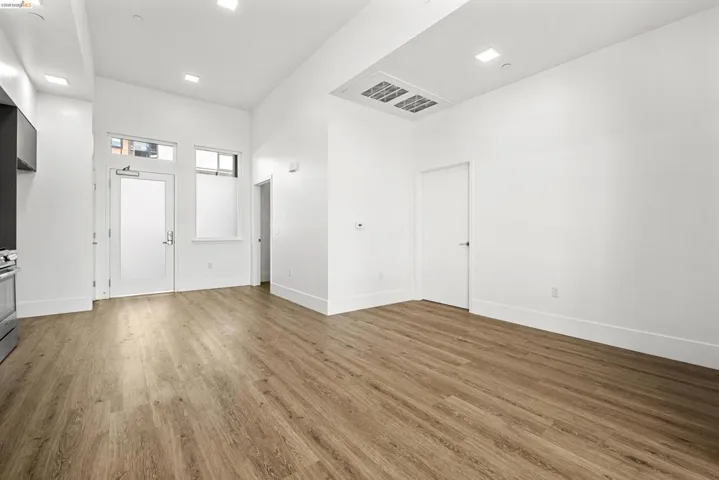 Foyer with wood finished floors and a towering ceiling