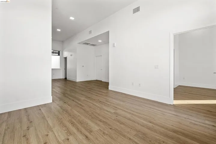 Spare room with light wood-style floors and recessed lighting