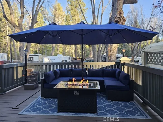 Patio seating with fire pit and wide umbrella