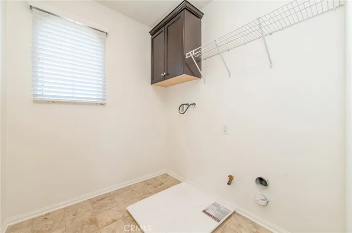 Upstairs laundry room with a window