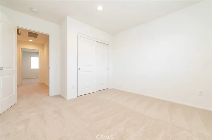 The 4th bedroom next to the full bath with window facing front