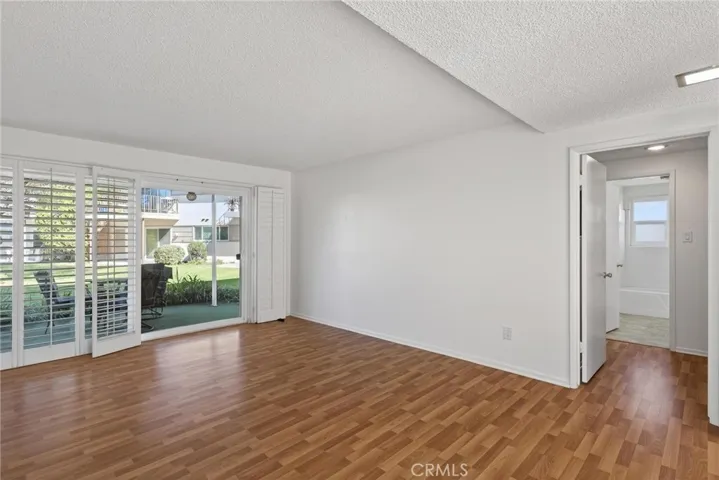 another view of living room facing hall to bedrooms, bathroom and laundry area
