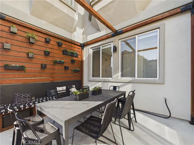 Private back patio with plant wall is such a special feature to this home.