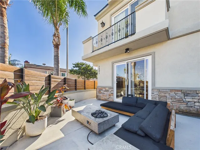 Welcome friends and family to this cozy front facing patio with a fire pit and sofa.
