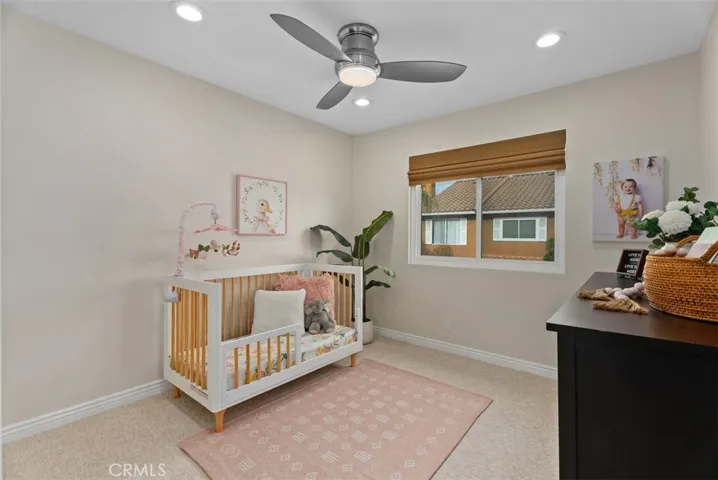 third bedroom with custom closet with built-ins, LED recessed lighting, & ceiling fan
