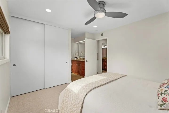 primary suite with 1 of 2 custom closets with bulit-ins