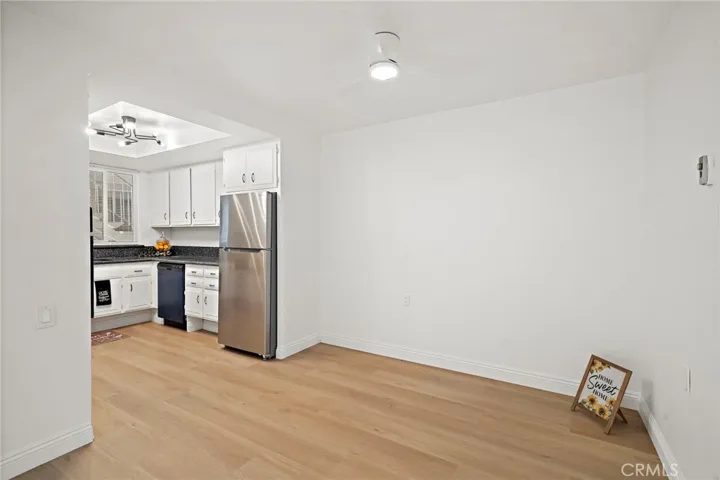 Showing Dining area with ceiling fan light combination, new flooring with crown molding throught and           conveniently adjacent to the kitchen.