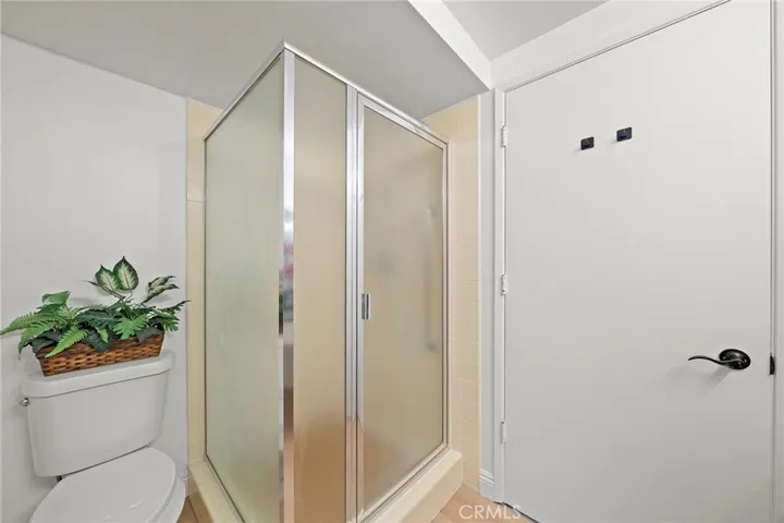 Guest Bathroom with free standing enclosed shower stall.