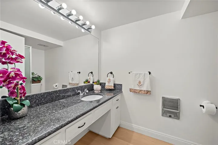 View of the spacious Guest bathroom with granite counter-tops.