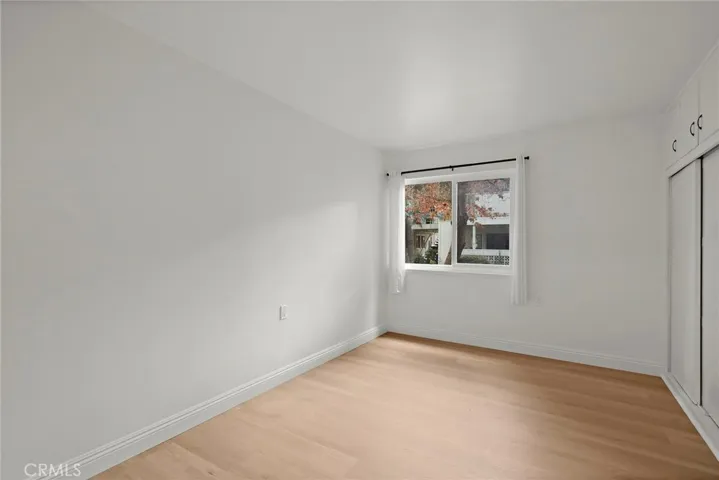 Guest Bedroom with  double-pane window natural light, newly painted and baseboard with new flooring, 
pane- window.