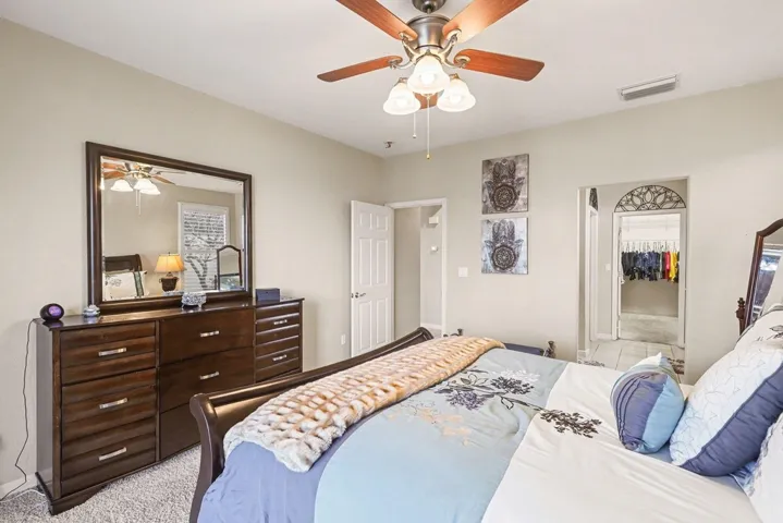 Bedroom featuring ceiling fan and light carpet