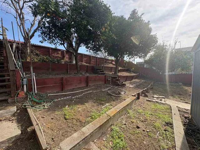 Fenced backyard with a vegetable garden