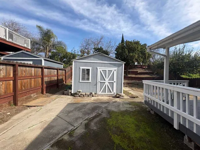 View of shed featuring a fenced backyard