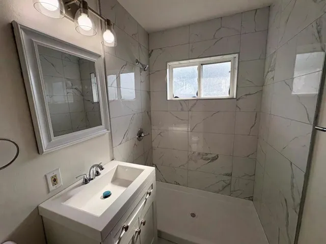 Bathroom featuring a stall shower and vanity
