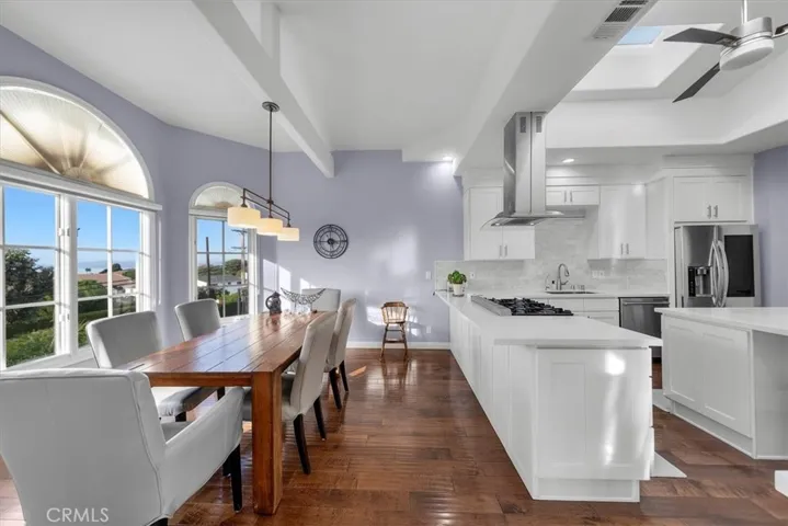 Updated kitchen open to sunlit breakfast/casual dining area