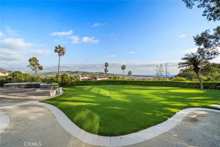 Grassy lawn leads to large recreation room at same level