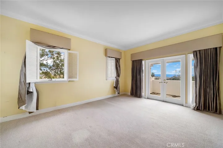 Secondary bedroom with balcony looking to ocean