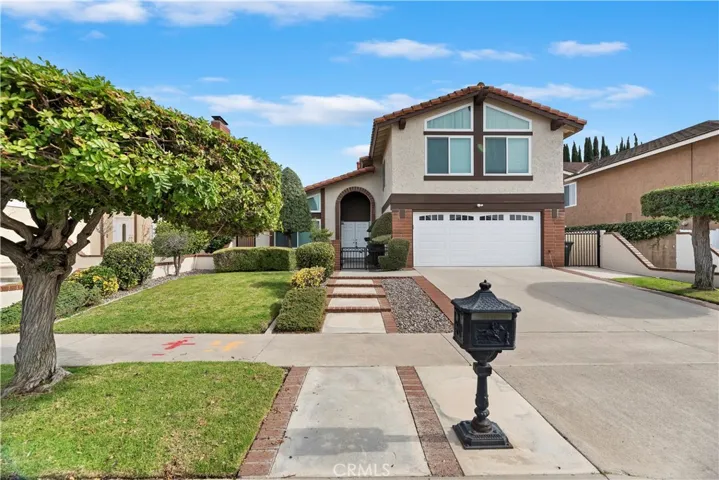 Outstanding curb appeal with manicured landscaping and an inviting front entry in a desirable Lake Forest neighborhood