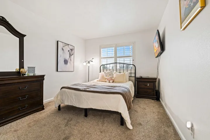 Carpeted bedroom featuring baseboards