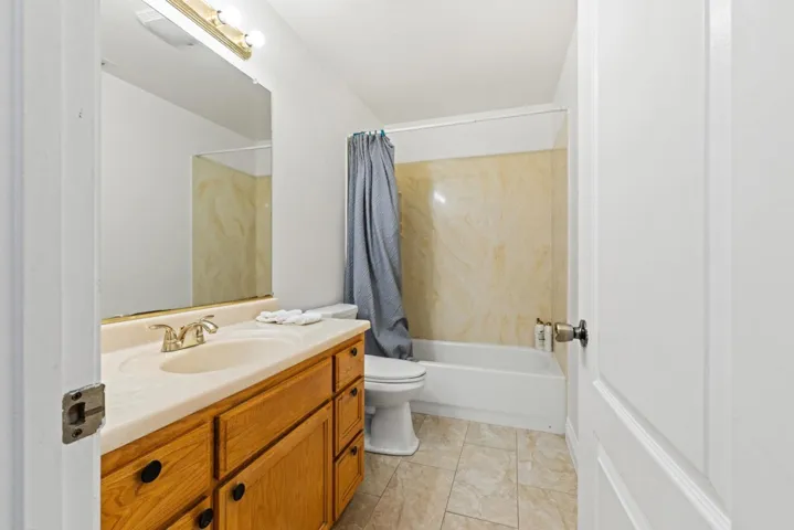 Full bath featuring vanity and  shower combination