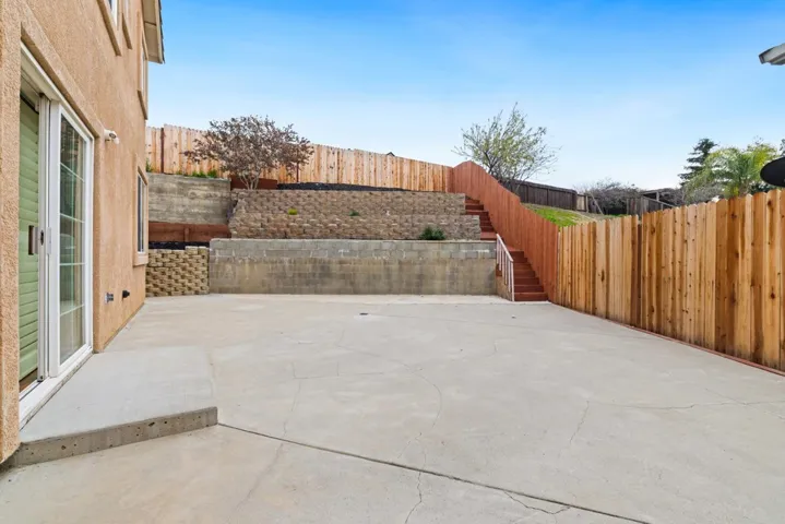 Fenced backyard featuring a patio