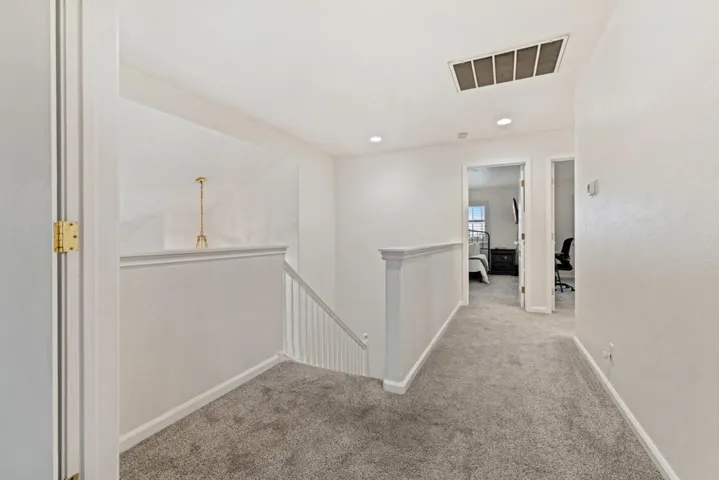 Corridor featuring an upstairs landing, carpet, and recessed lighting