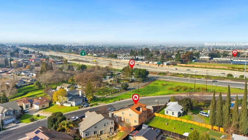Aerial view of property's location featuring nearby suburban area and a main thoroughfare