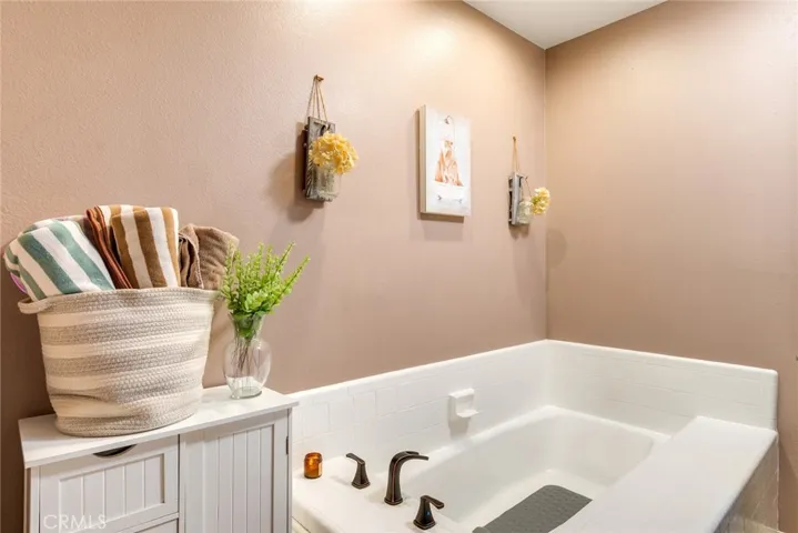 Primary bathroom featuring a deep soaking tub, perfect for relaxation.