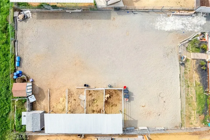 Overhead view of the equestrian area featuring a  well-maintained riding area with covered stalls and secure fencing—ideal for horses, training, and daily care.