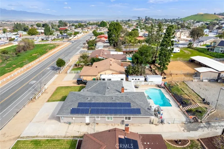 Aerial view of 3090 Norco Drive highlighting the expansive lot, RV parking, solar panels, and backyard with pool and spa
