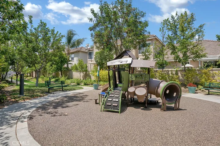 The nearby tot lot provides a cheerful setting for play and outdoor enjoyment.