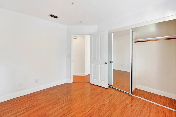 Unfurnished bedroom with a closet and light wood-style flooring