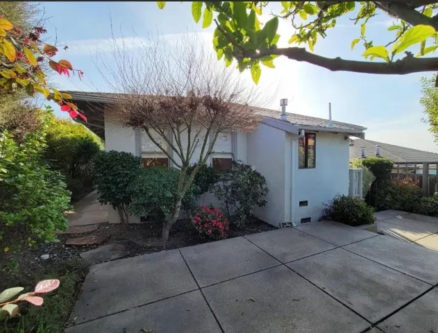 View of side of home with stucco siding