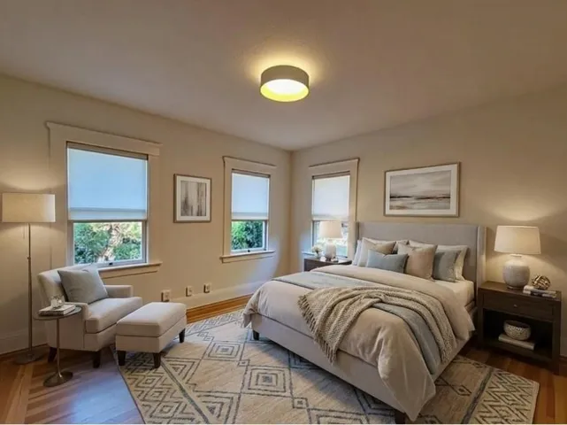 Bedroom featuring wood finished floors and baseboards