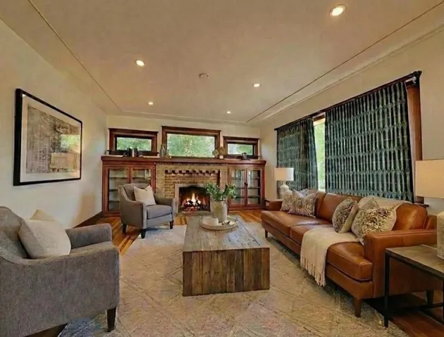 Living room featuring a fireplace, light wood finished floors, healthy amount of natural light, and recessed lighting