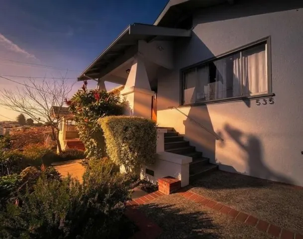 Property exterior at dusk featuring stucco siding and​​‌​​​​‌​​‌‌​​‌​​​‌‌​​​‌​​‌‌​​‌‌​​‌‌​​​​ stairway
