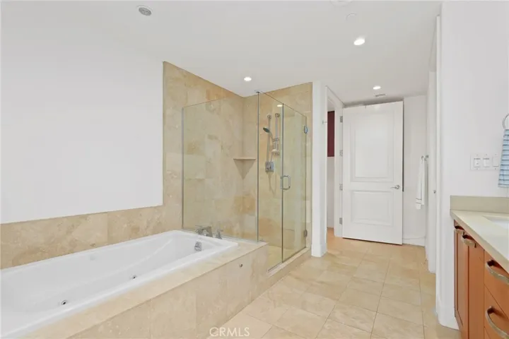 Soaking tub, walk-in shower, walk-in closet in primary bathroom