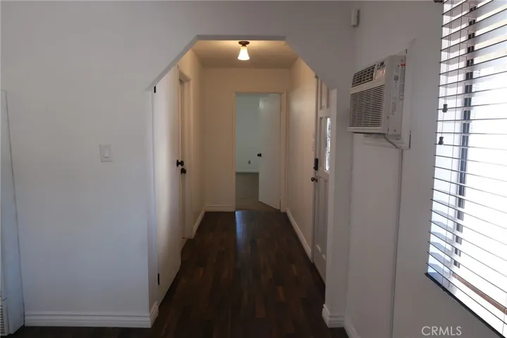 Interior hallway connecting living room to primary bedroom