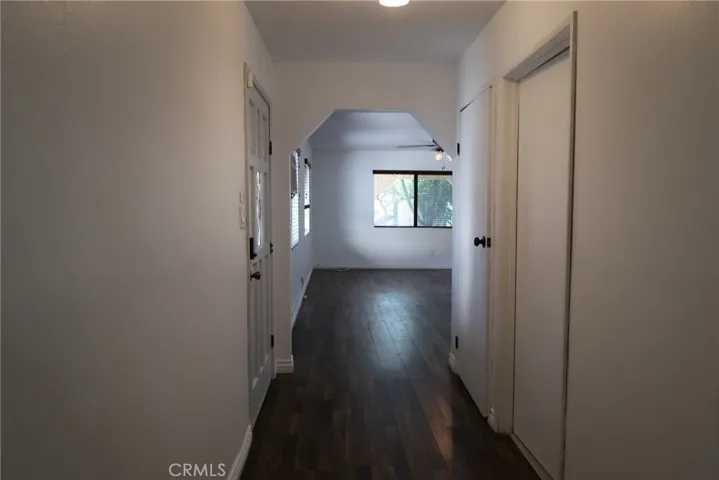 Interior hallway connecting primary bedroom to living room