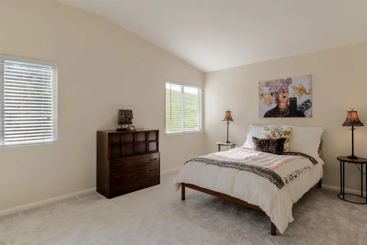 Carpeted bedroom with vaulted ceiling