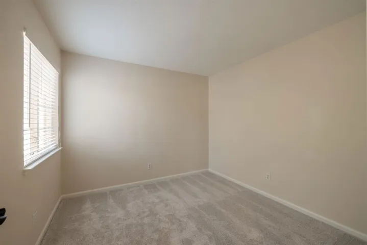 Unfurnished room featuring carpet flooring and baseboards
