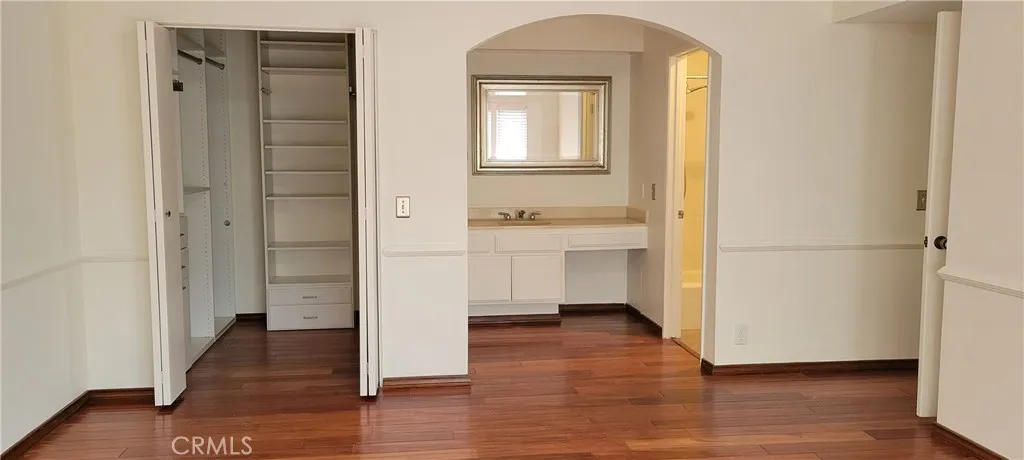 Primary bathroom vanity area and walk in closet