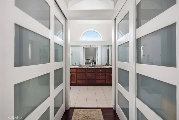 His and hers closets on separate sides in master