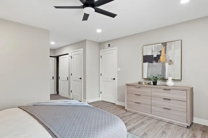 Bedroom featuring light wood-type flooring, a ceiling fan, and recessed lighting