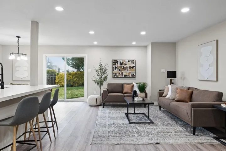 Living area with light wood-style flooring and recessed lighting