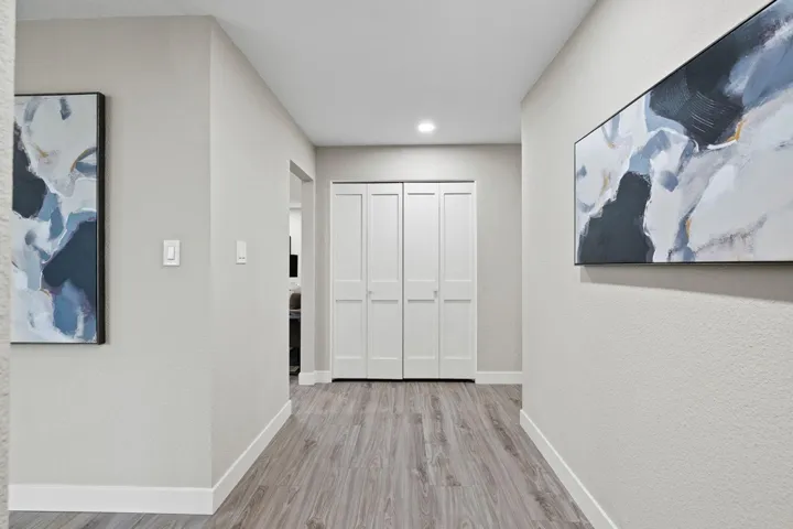 Hall with light wood-type flooring and baseboards